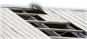 Metal roof being peeled back over wood framing for blog article